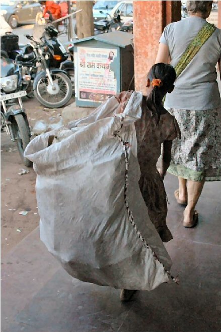 a girl with a bag of rags in Jaipur
